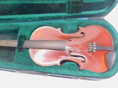 A violin, with two piece back, labelled Medio Fine, length of back 36cm and a violin bow. - 2