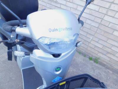 A Quingo Vitess mobility scooter made by Quintell and battery charger. - 2