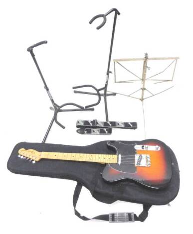 A Fender Telecaster electric guitar, 97cm L, two guitar stands, a lectern, fender strap and fitted case.