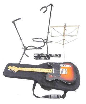 A Fender Telecaster electric guitar, 97cm L, two guitar stands, a lectern, fender strap and fitted case.