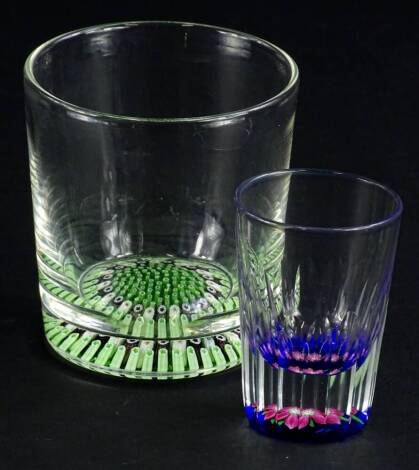 A Whitefriars tumbler, with mainly green millefiori decoration to the base, and a small Whitefriars shot type glass with pink flower to the base.