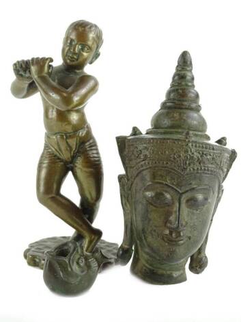 A bronze figure of oriental men playing a pipe of flute, lacking instrument, 13cm H, a bronze Buddha figure and a small bronze fish.