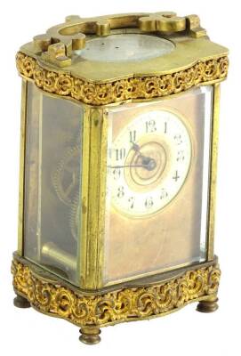 A late 19thC French carriage timepiece, the gilt brass case decorated with scrolls etc., the enamel dial with Arabic numerals, 17cm H overall.