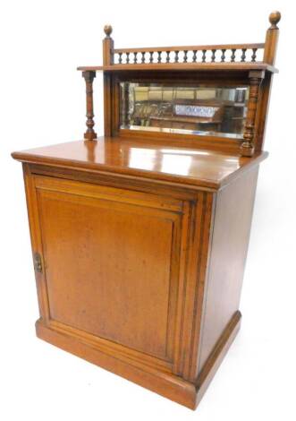 A late Victorian oak chiffonier by Edwards and Roberts, he raised back with spindled turned gallery and a shelf on turned supports with bevelled mirror plate, the base with a single panelled door enclosing a shelf on a plinth, stamped to top of door, 144c