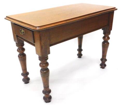 A Victorian mahogany and pitch pine side table, the rectangular top with a moulded edge, with a plain frieze and a side drawer on turned tapering legs, 64cm H, 90cm W.