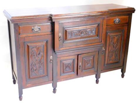 A Victorian walnut breakfront sideboard, the top with a moulded cornice above two drawers flanking a central narrow carved and panel cupboard, above four further panelled doors on turned legs, 150cm W.