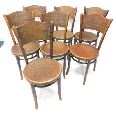 A set of seven Thonet beech bentwood chairs, each with a pressed simulated scale back and circular seat, on splayed legs, some stamped to underside.