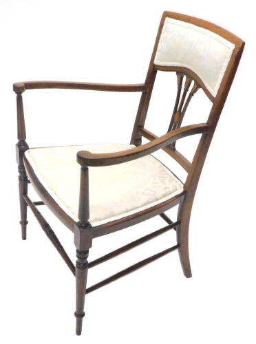 An Edwardian mahogany open armchair, with a padded back and seat, pierced splat and turned legs with stretchers.