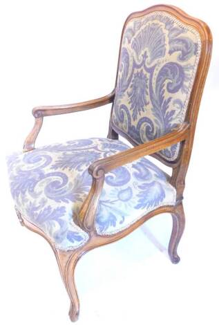 A Continental walnut open armchair, with a padded back and seat, upholstered in tapestry type fabric, on cabriole legs. Provenance: The property of Joan Stephenson, Kirkwood, North Church Walk, Newark, Nottinghamshire.