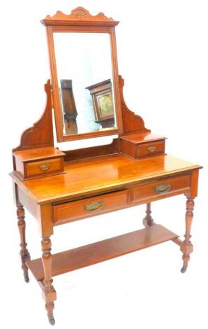 A late Victorian walnut dressing table, the top with a bevelled mirror plate on shaped supports with small trinket drawers, the base with two frieze drawers on turned legs with under tier with ceramic castors, 107cm W.