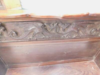 A collection of early 20thC and later furniture, to include a wall shelf carved with dragons etc., two bookracks and a glazed bookcase. (4) - 2