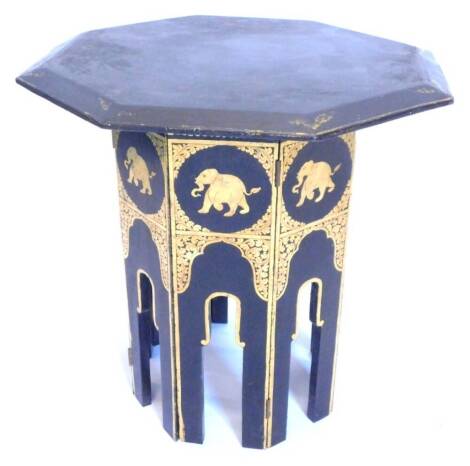 A 19thC papier mache occasional table, the octagonal top with a moulded edge, the faceted base decorated with gilt with Indian style elephants etc., (AF), 51cm W.