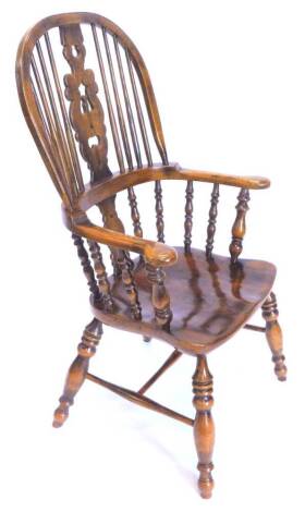 An ash and elm Windsor chair, with a pierced splat, solid seat on turned legs with H stretcher.