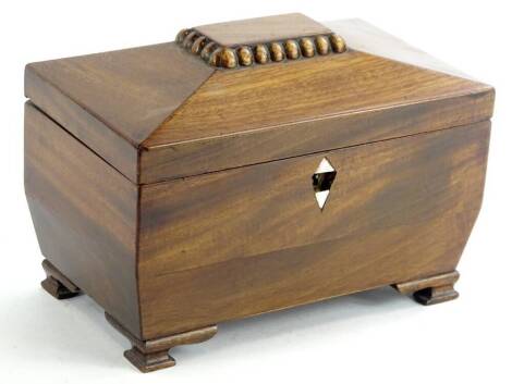 A Victorian mahogany sarcophagus shaped tea caddy, the hinged lid enclosing a relined interior, on ogee bracket feet, 19cm W.