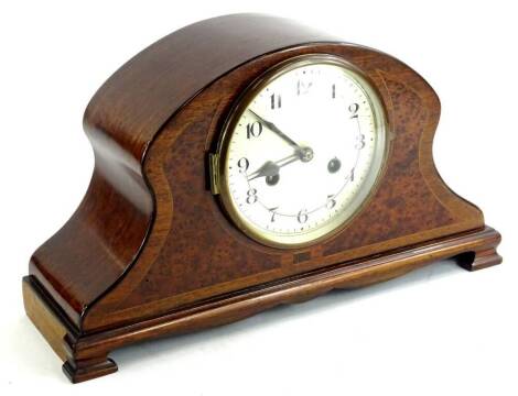 A mahogany and amboyna cased mantel clock, with a silvered dial on ogee bracket feet, 41cm W.