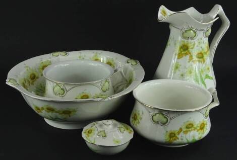 A Henry Alcock & Co semi porcelain part wash stand set, each piece decorated with yellow flowers and green leaves, in the Art Nouveau style, comprising wash jug and bowl, two chamber pots and a soap dish.