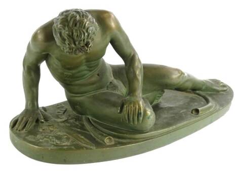 A 20thC bronzed plaster figure of the dying Gaul, on a rectangular base with rounded ends, unsigned, 57cm W.