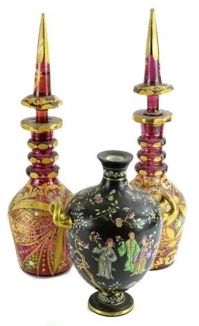 A pair of Bohemian style ruby tinted decanters, each with a Middle Eastern style coloured enamel decoration, 49.5cm H and a Copeland two handled vase, decorated with oriental figures (AF).