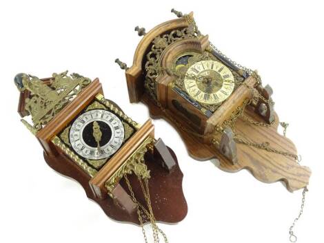 Two 20thC Dutch stoelkloks, each with a silvered dial and shaped crest.