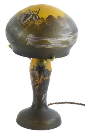 An etched glass table lamp and shade, decorated with flowers, dragonfly etc., bearing the name Galle, 34cm H.