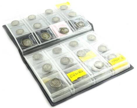 An album containing one hundred and twelve silver 3d coins, from Victorian onwards.