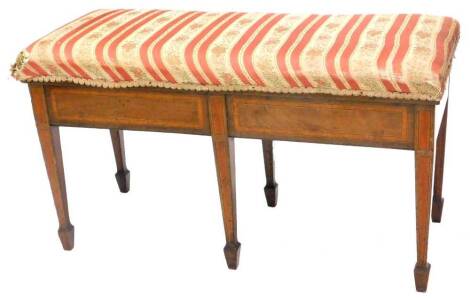 An Edwardian mahogany satinwood cross banded duet stool, with a hinged padded seat on square tapering legs, 90cm W.