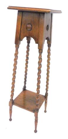 An oak plant stand, the square top with a moulded edge on spirally turned supports with under tier, 107cm H.