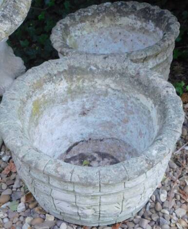 A pair of composite garden jardinieres or planters, each with decoration of patera etc.