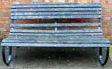 A wrought iron and slatted garden bench, (AF), 152cm W.