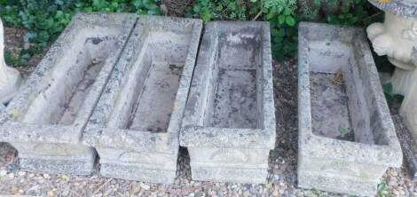 A set of four composite garden troughs, each decorated with shell motifs, 90cm W.