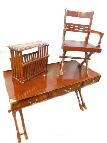 An Eastern hardwood brass and copper inlaid writing table, the rectangular top above three frieze drawers on part turned end supports with turned stretcher, 137cm W, a desk chair and a Canterbury or magazine rack. (3)