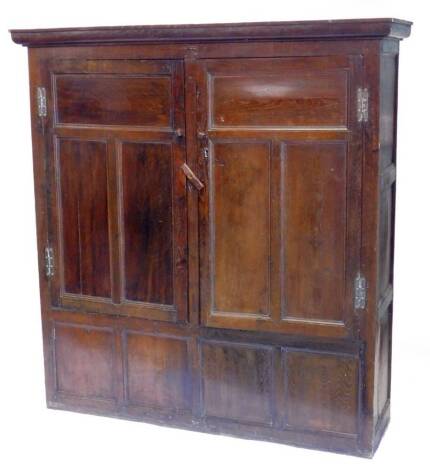 An early 18thC oak cupboard, with a moulded cornice above two panel doors, with a panel base, adapted, 156cm W.