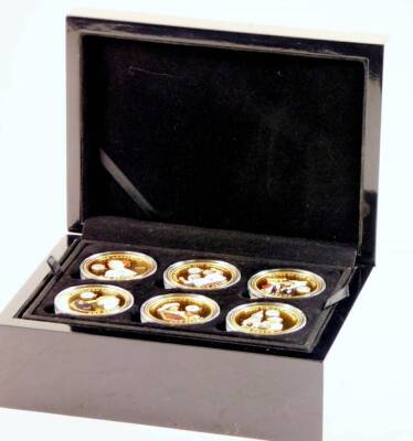 A cased Queen Elizabeth II Collection Crowning Glory coin set, each coin sterling silver with 24ct gold finish. (boxed with some paperwork)