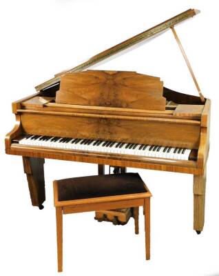 An Art Deco Monington & Weston walnut cased baby grand piano, with overstrung metal frame and adjustable inner music stand, with two pedals, 99cm H, 145cm W, 131cm D, and a piano stool. (2)