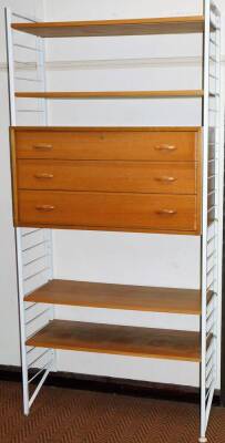 A 20thC Ladderax teak unit, with two painted metal side sections, centred by three drawers and shelves, 199cm H, 93cm W 40cm D.