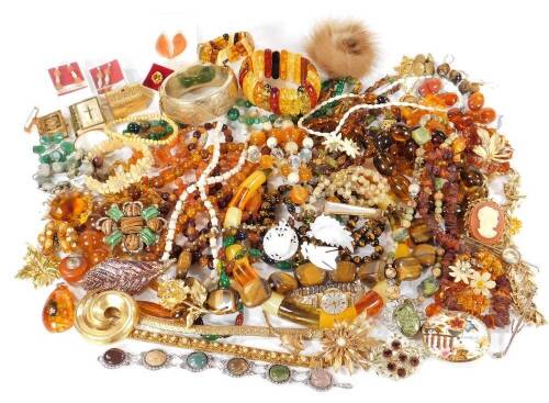 A quantity of costume jewellery, to include beaded necklaces, imitation amber, imitation tiger's eye, drop earrings, cameo style brooch, bangles, earrings, etc. (a quantity)