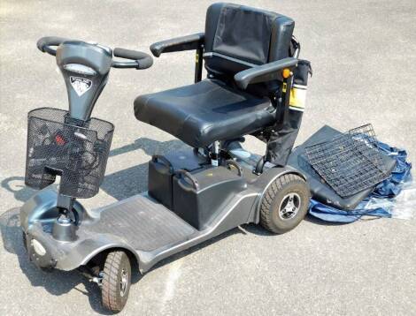 A Sterling Sapphire four wheeled mobility scooter, with front basket, charger attachment with canvas bag to the back, 95cm H.