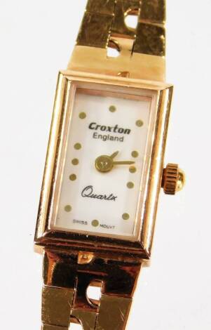 A Croxton ladies cocktail watch, with rectangular white enamel dial, on graduated and pierced gold bracelet, marked to case and bracelet, 14K, in W Croxton box.