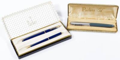 A Parker 51 cased fountain pen, in chrome and grey trim, 14cm W, a Parker Slim Fold pen and pencil set, in blue with gilt trim, cased. (2)