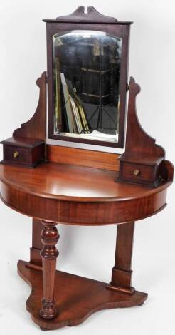 A Victorian mahogany duchess dressing table, the rectangular mirror flanked by scroll stiles, with two drawers above a D-end section and turned front leg on a platform base, terminating in compressed feet, 157cm H, 90cm W, 50cm D.