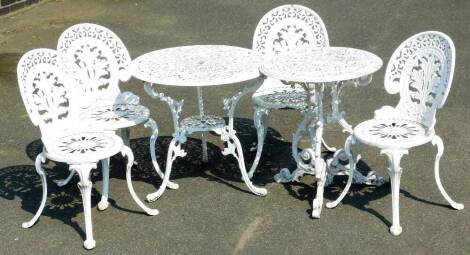 A late 20thC rococo style metal garden patio suite, comprising four chairs and two graduated tables, 67cm H, 74cm Dia. etc. each with pierced tops on triple scroll legs.