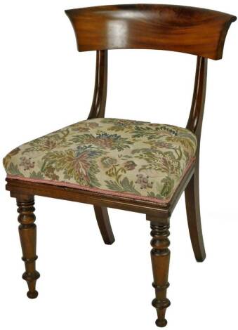 A Victorian mahogany dining chair, with over run cresting rail on inverted supports, above an overstuffed seat in floral material on turned front and sabre back legs, 80cm H.