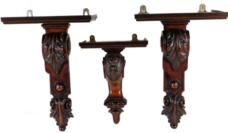 A pair of Victorian mahogany wall sconces, with scroll supports, 38cm H, and another similar. (3)