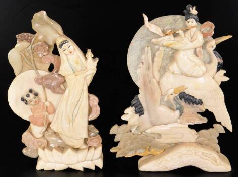 Two Chinese Republic period soapstone carvings, the first of a lady and storks in flight, with a circular back, 29cm H, the second a lady and child on a naturalistic setting, one labelled. (2)