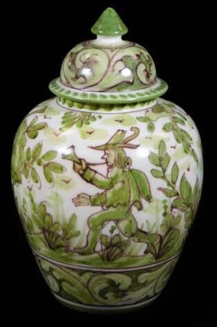 A 20thC Portuguese FCA Studio style vase, decorated with figure blowing horn before a castle in a woodland setting, predominantly in green, with a compressed domed lid with shaped finial, marked beneath, 32cm H.