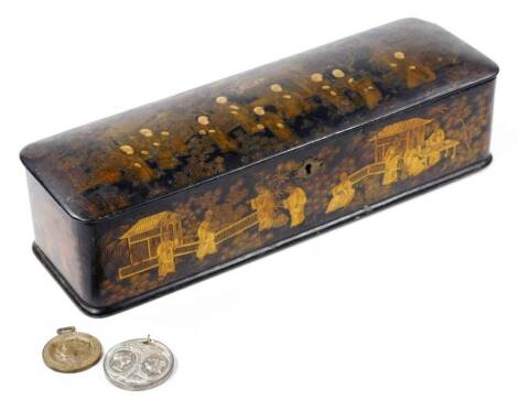 A Japanese black lacquer glove box, with gilt highlights, decorated with many figures before buildings and trees, 31cm W, and two commemorative medallions. (3)