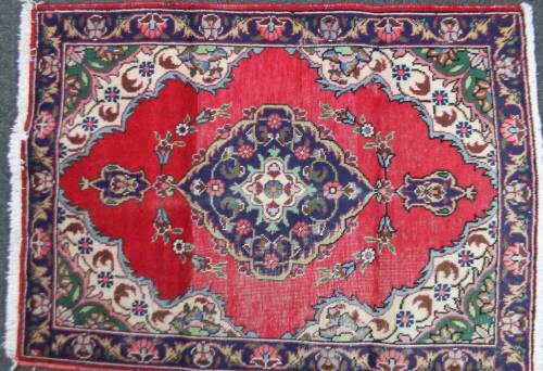 A Tabriz rug, in red and blue, 140cm x 110cm.