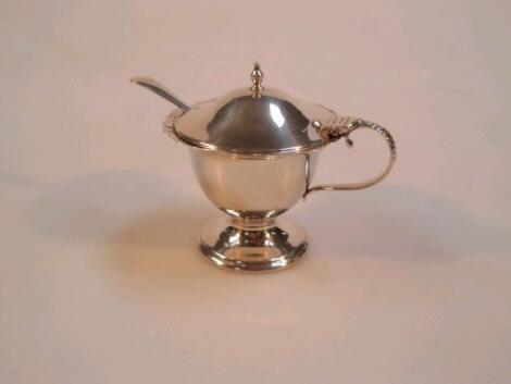 An Edwardian silver mustard pot with blue glass liner and spoon