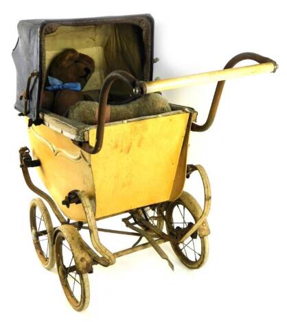 A vintage child's pram, with articulated leather canopy on four wheels, 74cm H, and various soft toys, etc. (a quantity)