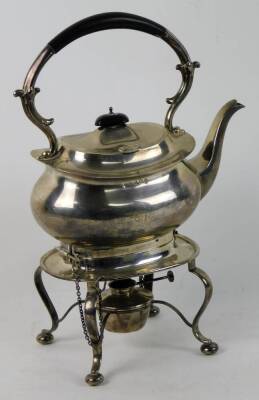 A George V silver tea kettle and burner stand, the kettle of squat baluster form, the rigid scrolled handle with ebonised insulating handle on a rectangular base with four cabriole legs on bun feet around a plain central burner, 36oz, 36cm H. - 2